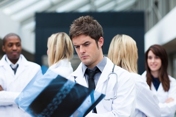 Fototapeta premium Serious doctor looking at an x-ray