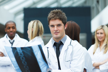 Young doctor with an x-ray looking at the camera