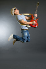 Fototapeta na wymiar passionate guitarist jumps in the air