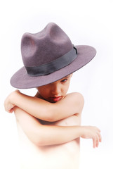 Little cute boy with hat and hands on chest