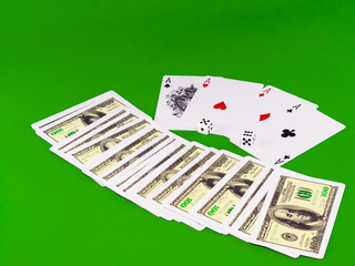 The dice and playing cards-four aces on green broadcloth.