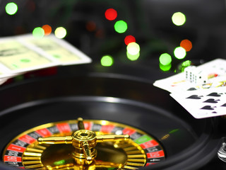 The casino roulette and playing cards. On background- casino