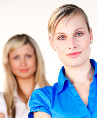Businesswoman looking at the camera with her colleague