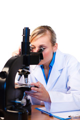 Attractive scientist looking through a microscope