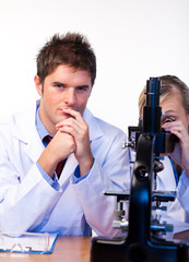 Scientists looking through a microscope