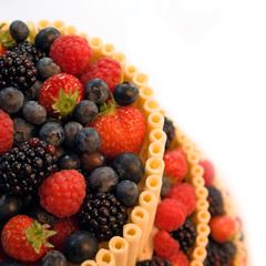 Berry cake with white chocolate over a white background