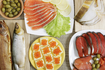 Assorted fishes and open sandwiches with red caviar