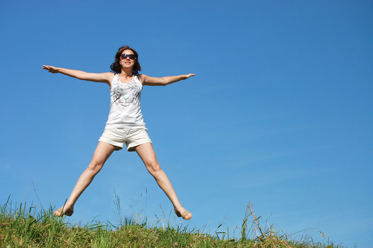 Girl Jumping Against The Beautiful Sky