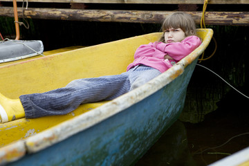 Children playing in yellow boat. Summer time