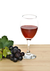 Goblet  and grapevine on table