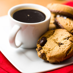 Cup of black coffee and chocolate cookies