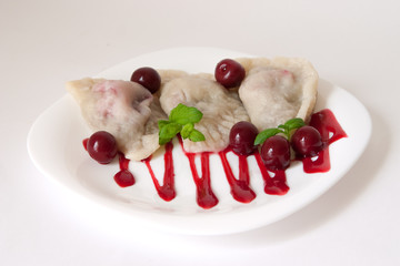 Cherry dumplings with cherry sauce and mint