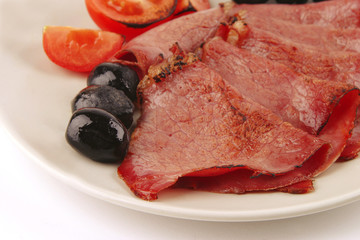 sliced served sausage with raw tomato