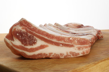 raw pork rips on a timber board