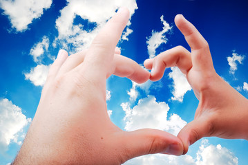 Heart shaped hands in beautiful sky