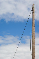 Wooden Electricity Pole on Blue, Clouded Sky