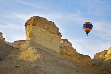 Fototapeta na wymiar Huge balloon above ancient mountains