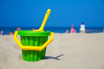 Plastic spade and bucket in sand © Sergios