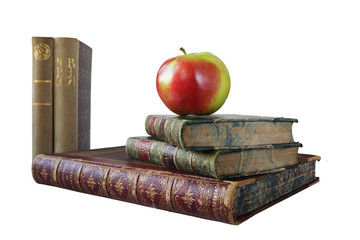 stack of vintage books, with an apple, isolated