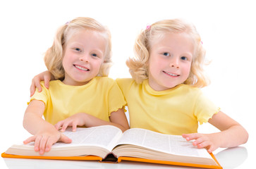 smiling little twinsgirls with book