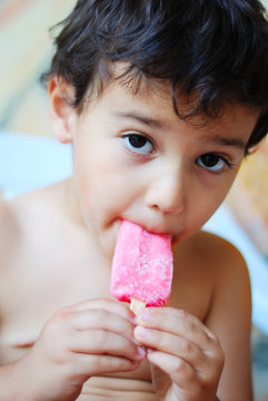 A Cute Kid With Ice Cream In Mouth