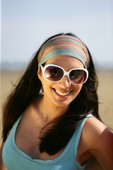 Portrait d'une femme souriante portant des lunettes de soleil
