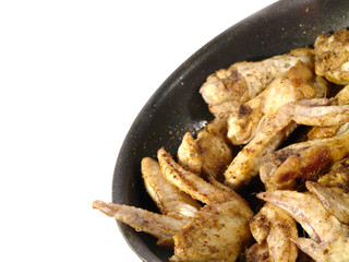fried delicious chicken wings on the frying pan