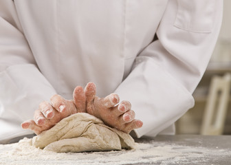 Chef kneading dough.