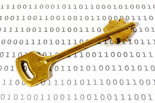 Golden key on a sheet with binary encrypted data