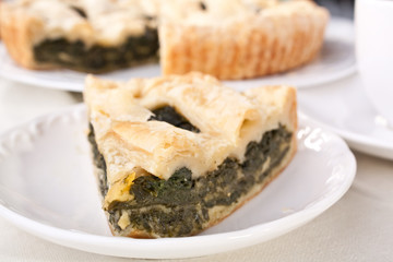 spinach pie piece on white plate