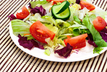 Fresh vegetable salad with tomato, lettuce, cucumber