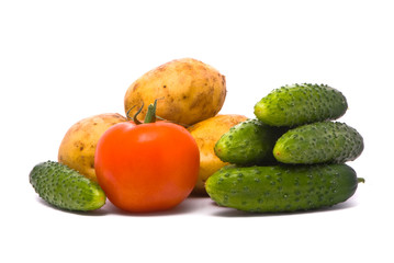 Fresh tomato, cucumbers and potatoes on studio white