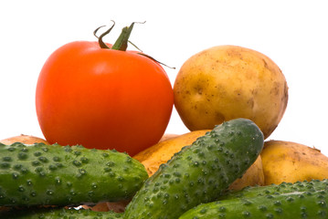 Fresh tomato, cucumbers and potatoes on studio white