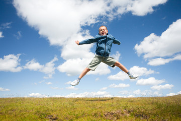 Fototapeta na wymiar Cute kid jumping for joy