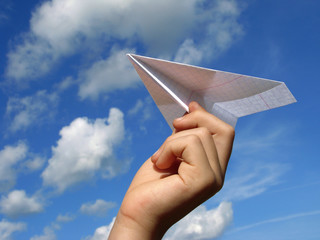 child hand with paper plane
