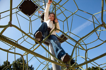 Girl climbing on playground set