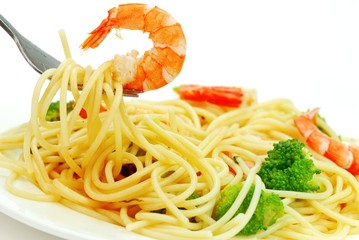Fork with pasta and shrimp isolated on white