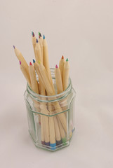 glass jar of coloured pencils