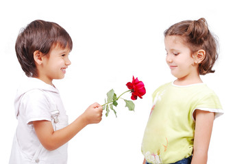 Very cute scene of two little children with rose