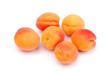 Ripe and juicy apricots on white