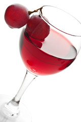 glass of red wine and grapes isolated