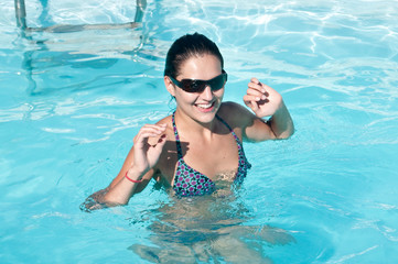 Woman with sunglasses in pool