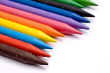 Many colorful wax crayons in a row (shallow depth-of-field)