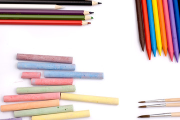 Colorful pencils, crayons, chalks and paintbrushes