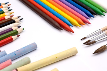 Colorful pencils, crayons, chalks and paintbrushes