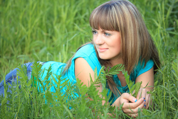 young beauty girl lies in grass