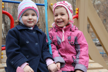 Two smiling girls on playground