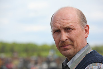 Portrait of middle-aged  man outdoor on cemetery