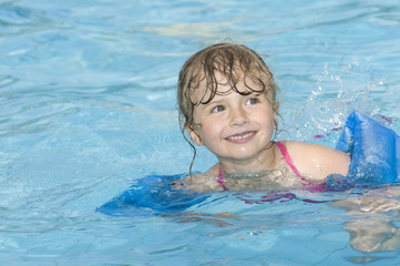 Fototapeta na wymiar Happy girl playing in water