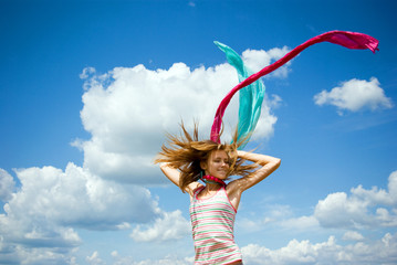 Beautiful young girl jumping in a sunny day